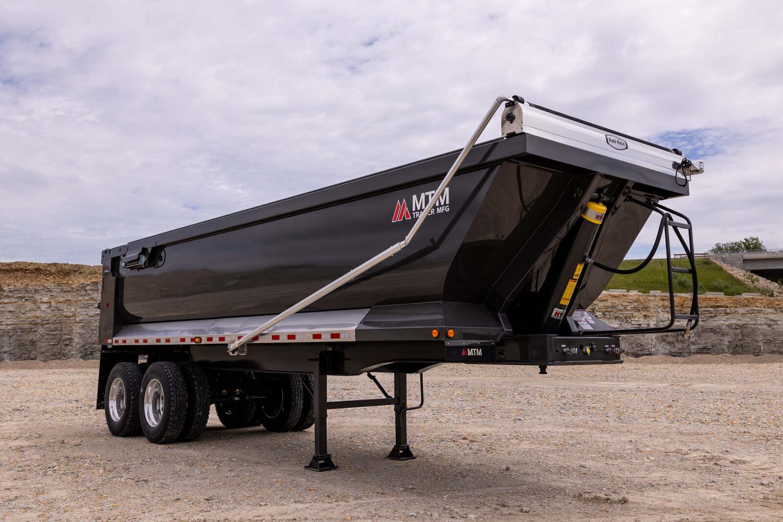 dark gray full-frame trailer in a quarry