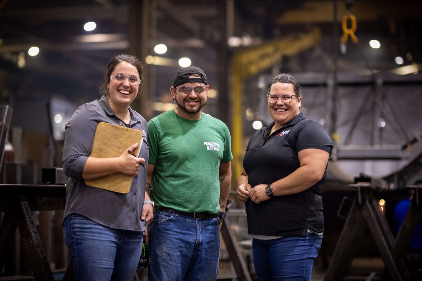 three people on the MTM factory floor