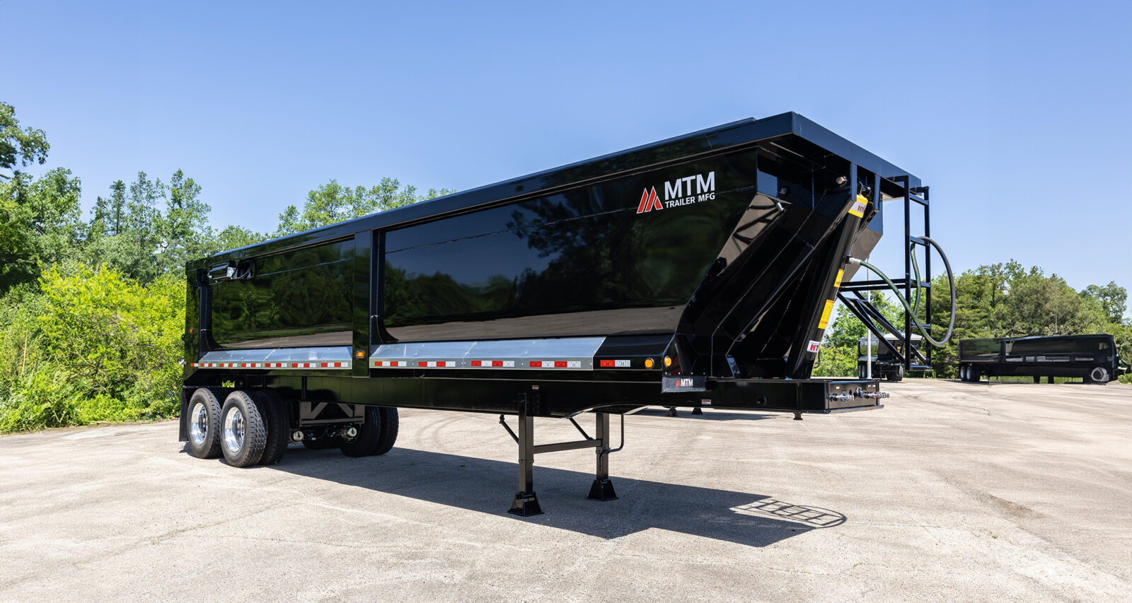 black heavy-duty full-frame MTM end-dump trailer
