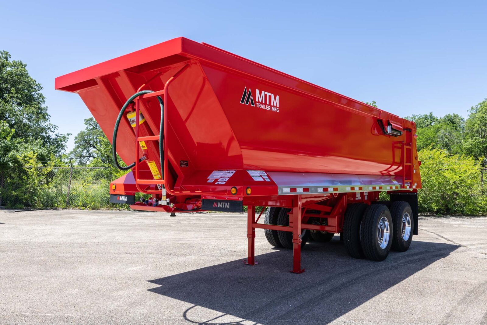 Red MTM quarter-frame end-dump trailer, view of the front