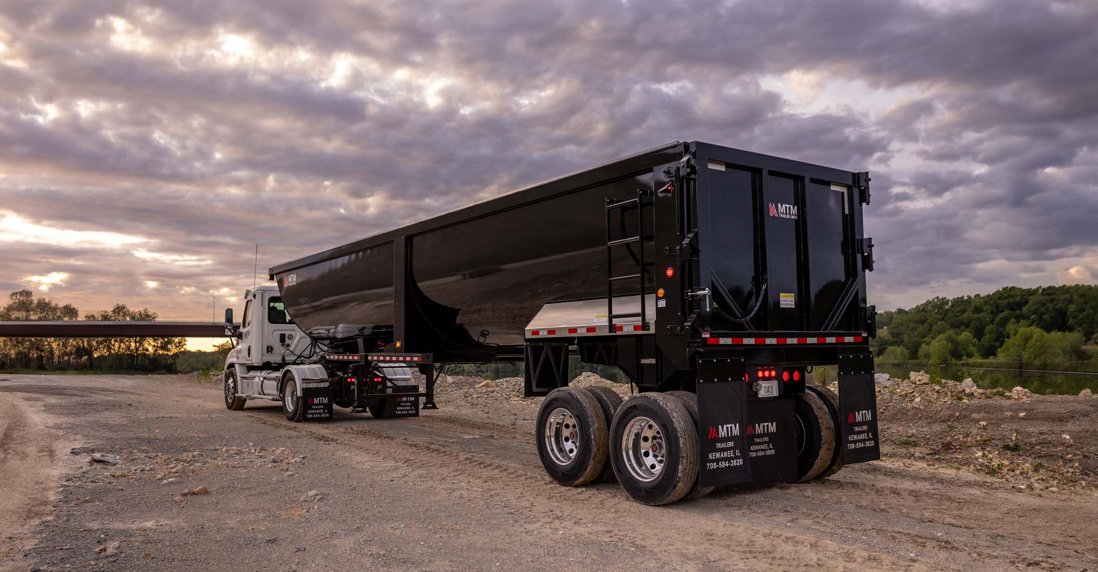 black 40' end-dump trailer in a quarry