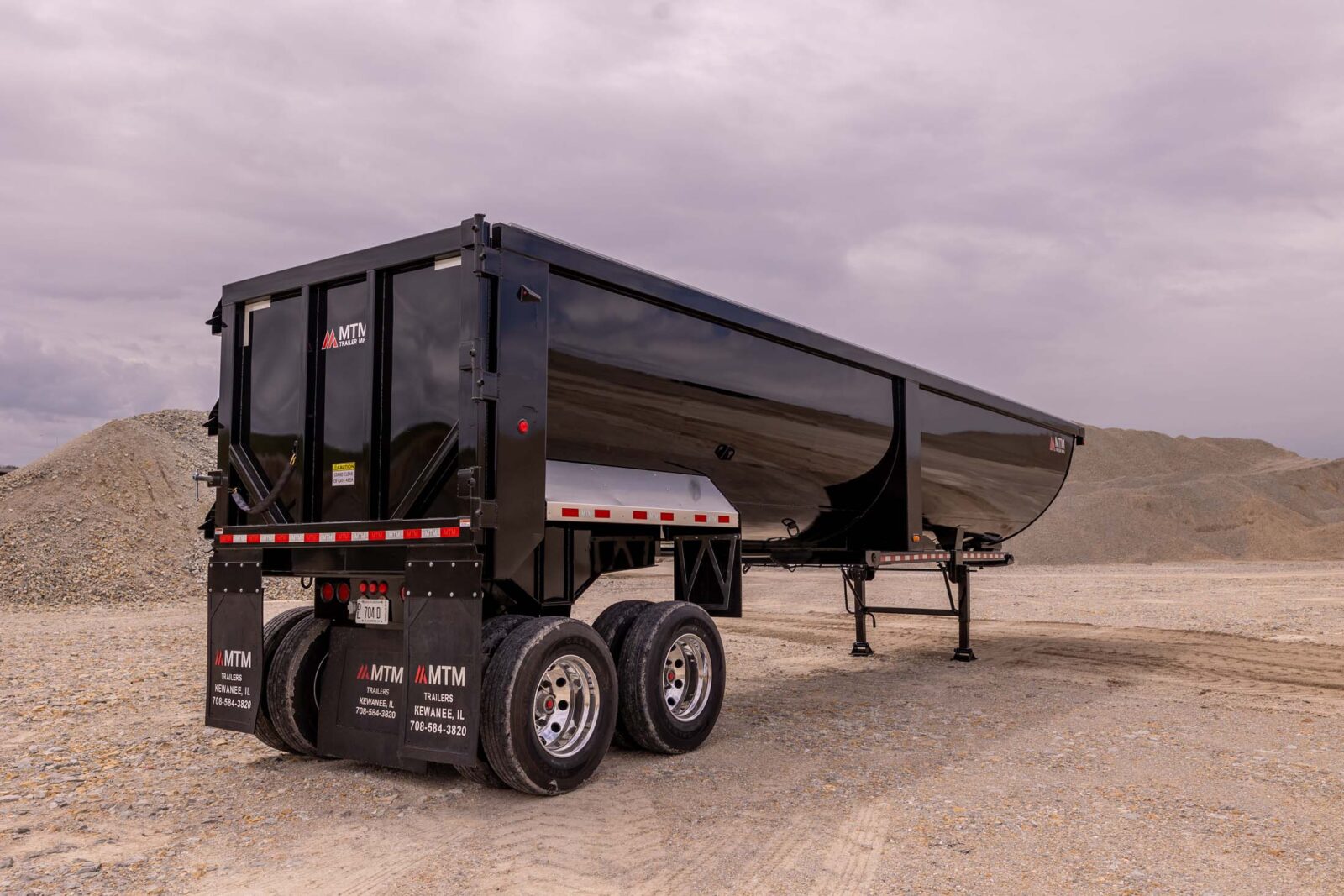 black 40' end-dump trailer in a quarry
