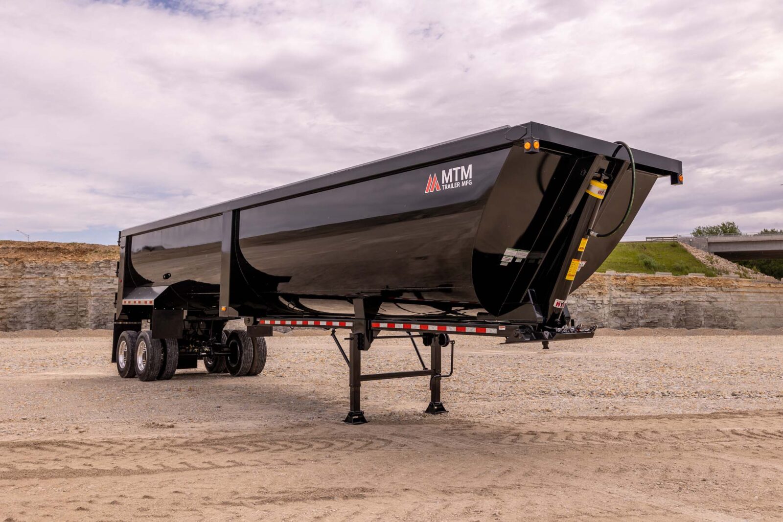 black 40' end-dump trailer in a quarry
