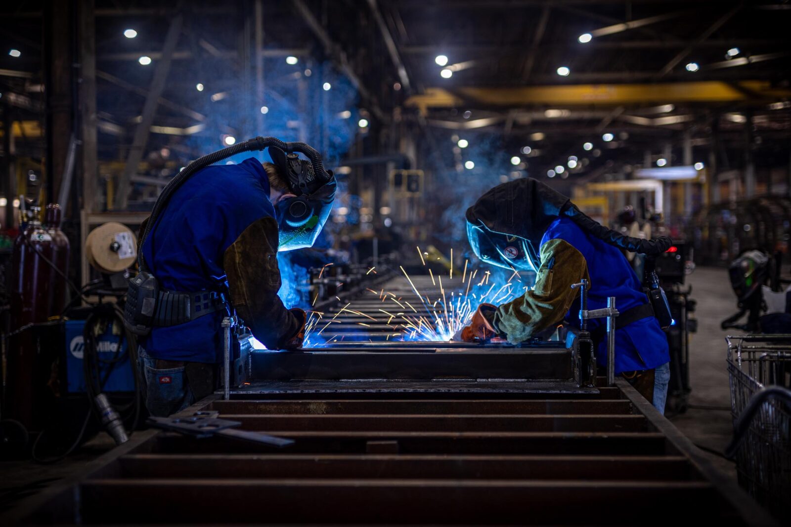Two welders working on a trailer in the MTM factory