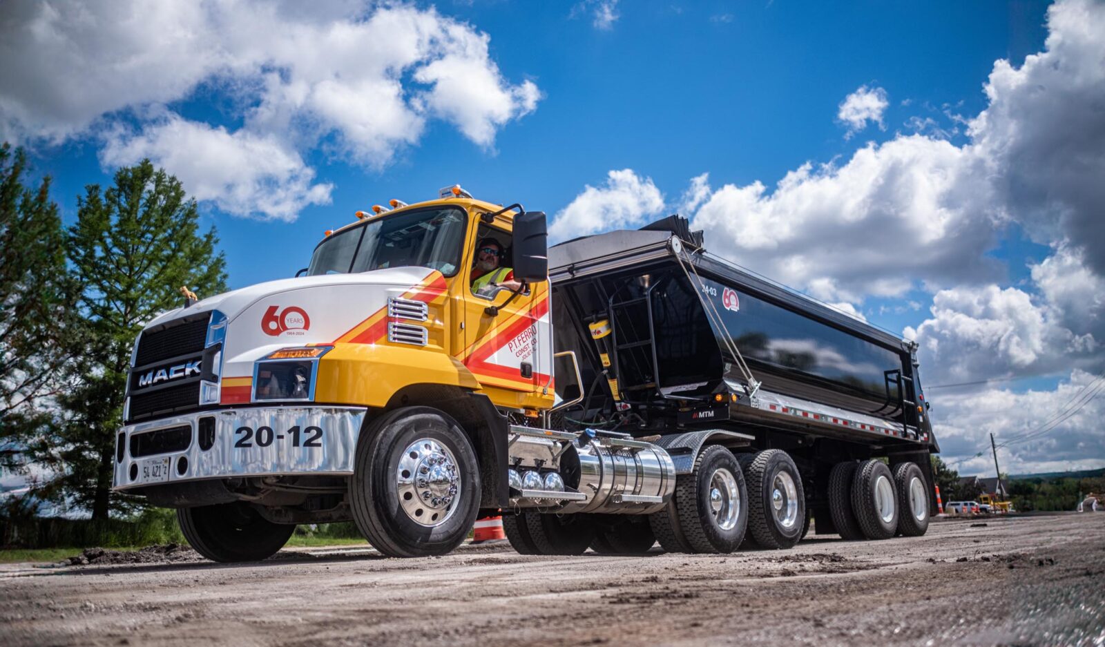 Yellow P.T. Ferro truck pulling a black MTM trailer