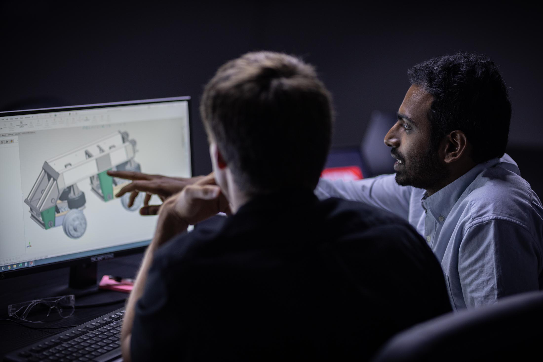 Engineers working on 3D renderings of an MTM Trailer