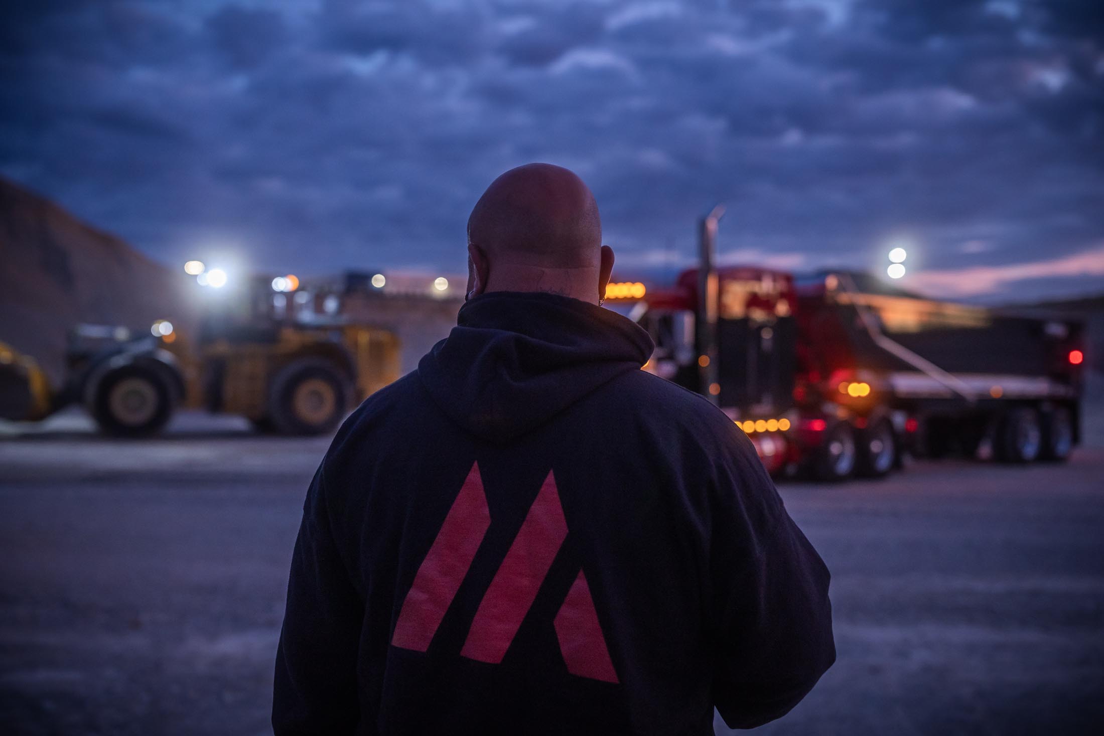 A driver in an MTM shirt standing in front of MTM trailer