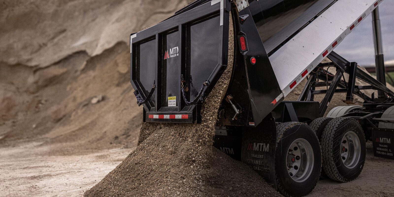 MTM Trailer dumping a load of sand