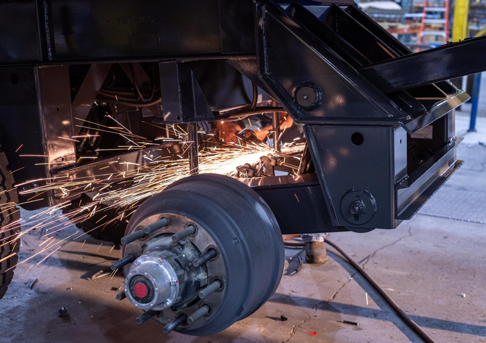 Someone repairing a trailer with sparks flying