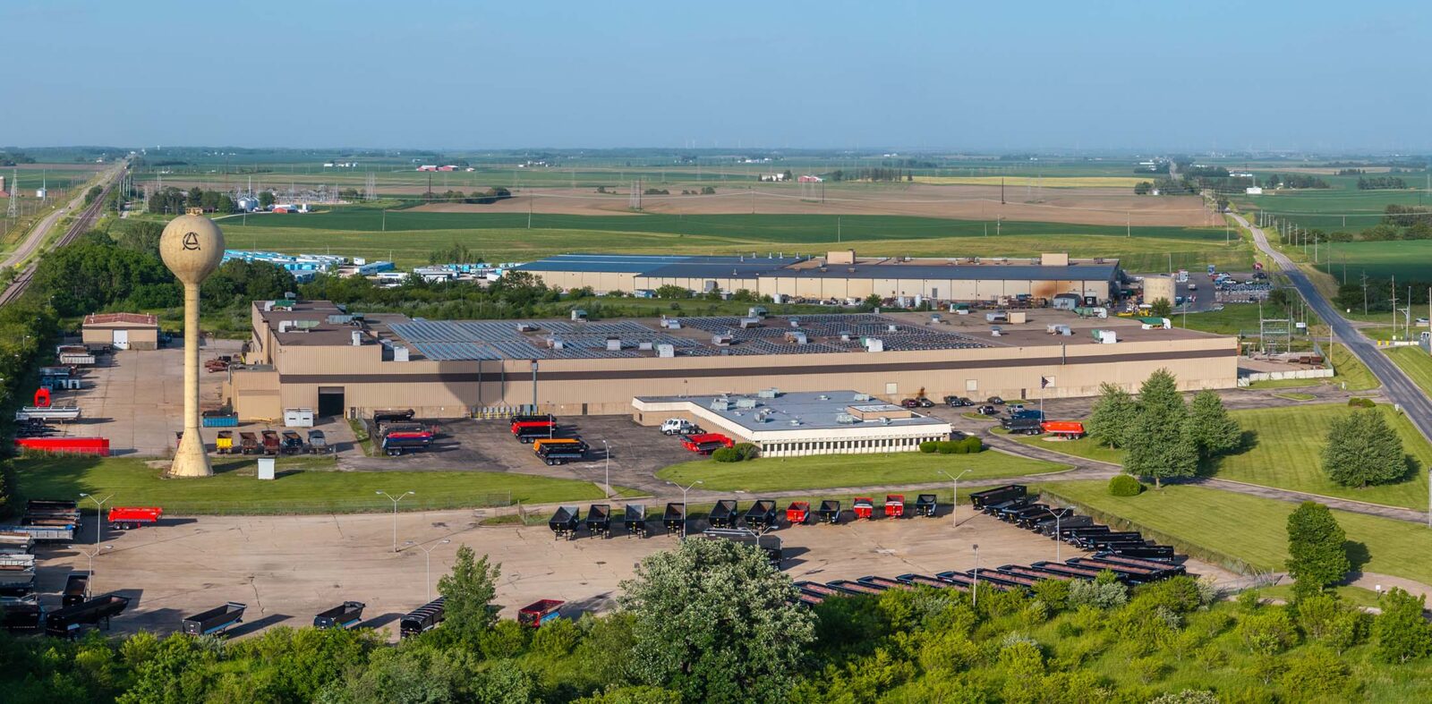 drone view of a factory building with trucks