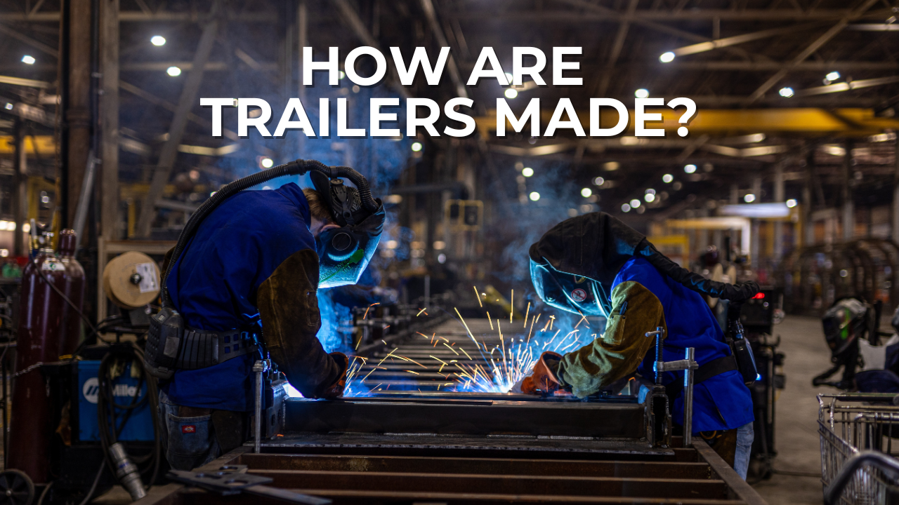 two welders working on an end-dump trailer