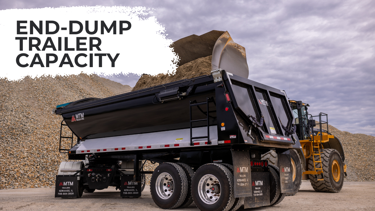 loader dumping into a quarter-frame end-dump trailer